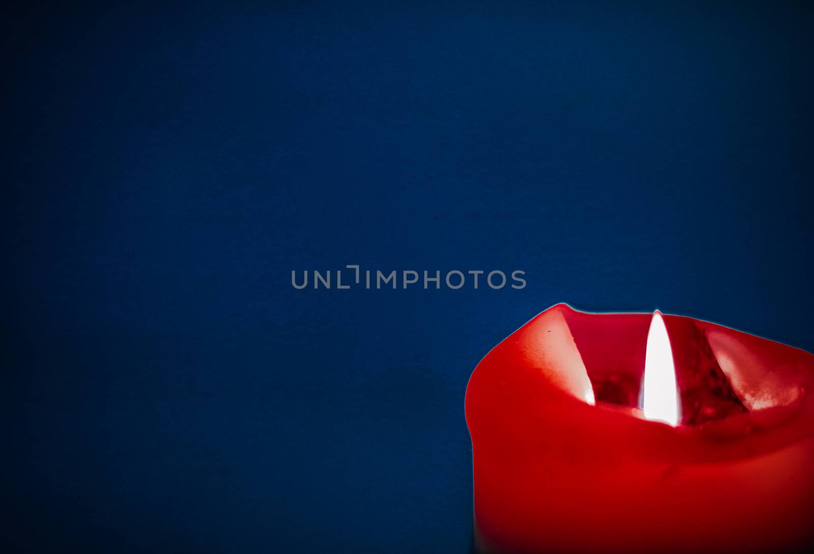 Red holiday candle on blue background, luxury branding design an by Anneleven