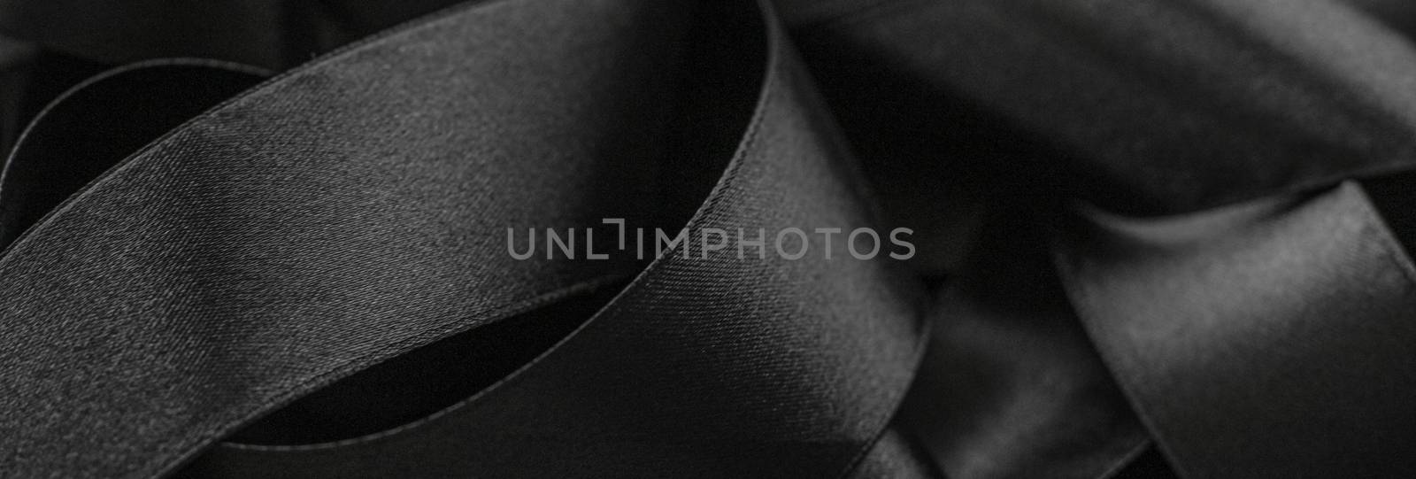 Black silk ribbon as background, abstract and luxury brand desig by Anneleven
