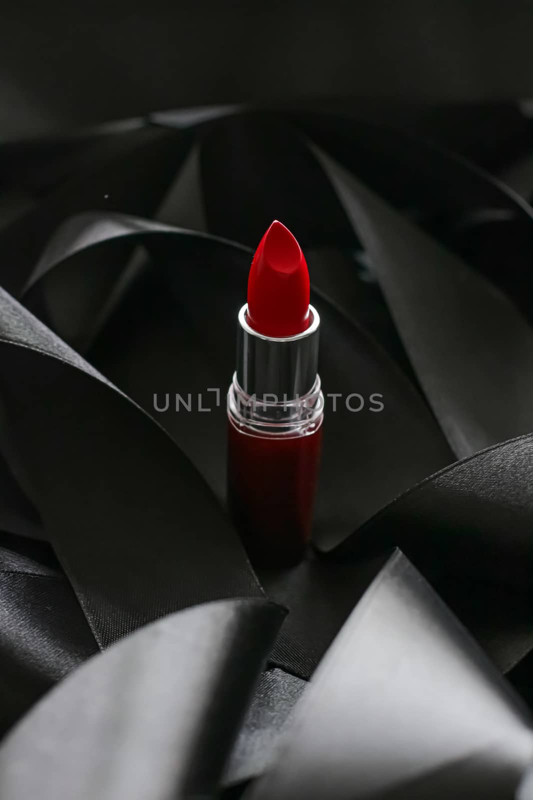 Red lipstick on black silk background, luxury make-up and beauty cosmetics