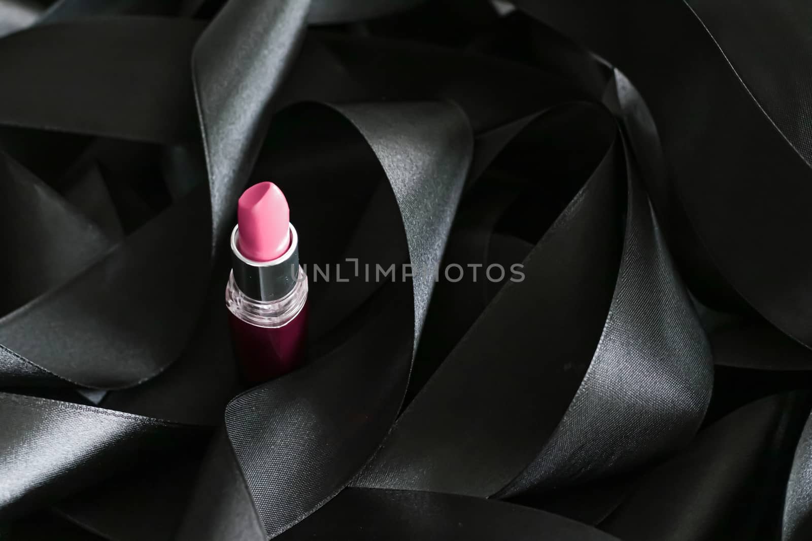 Pink lipstick on black silk background, luxury make-up and beauty cosmetics