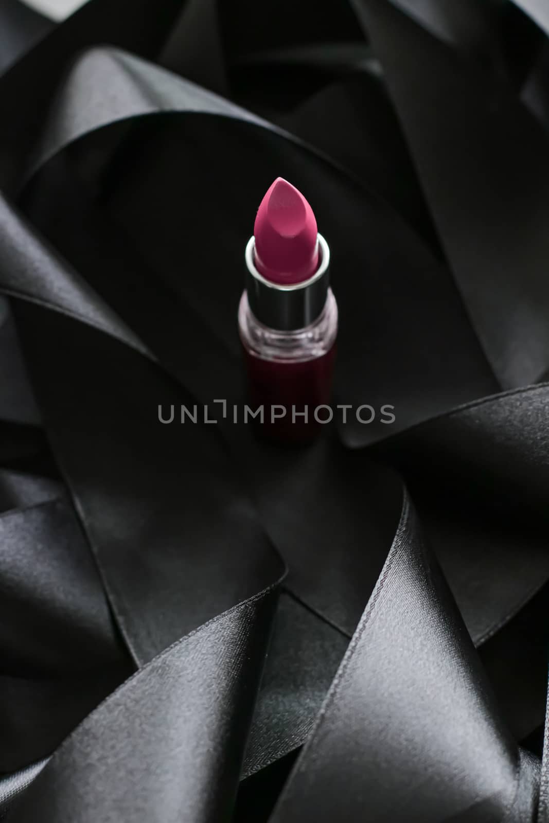 Pink lipstick on black silk background, luxury make-up and beaut by Anneleven