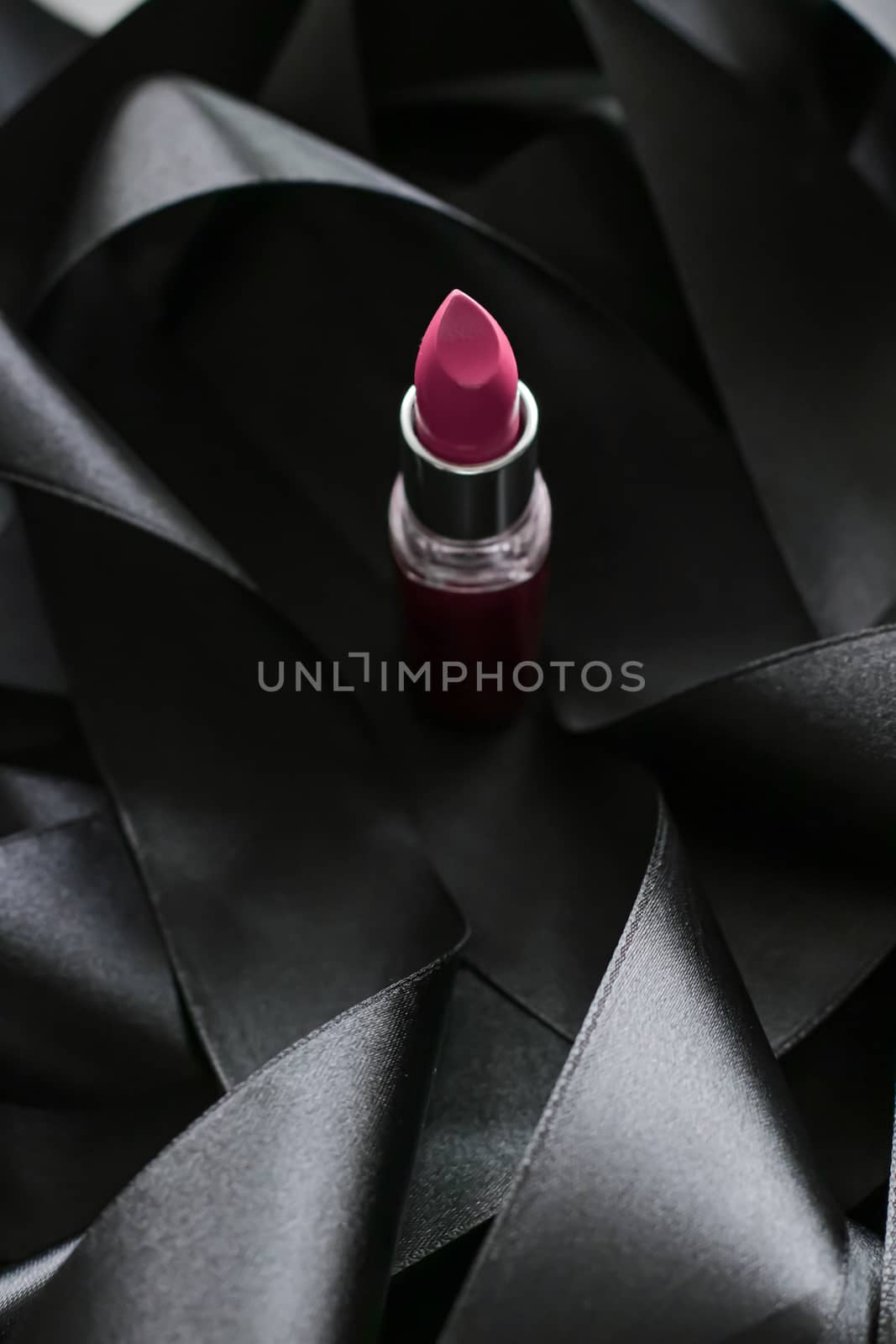 Pink lipstick on black silk background, luxury make-up and beauty cosmetics