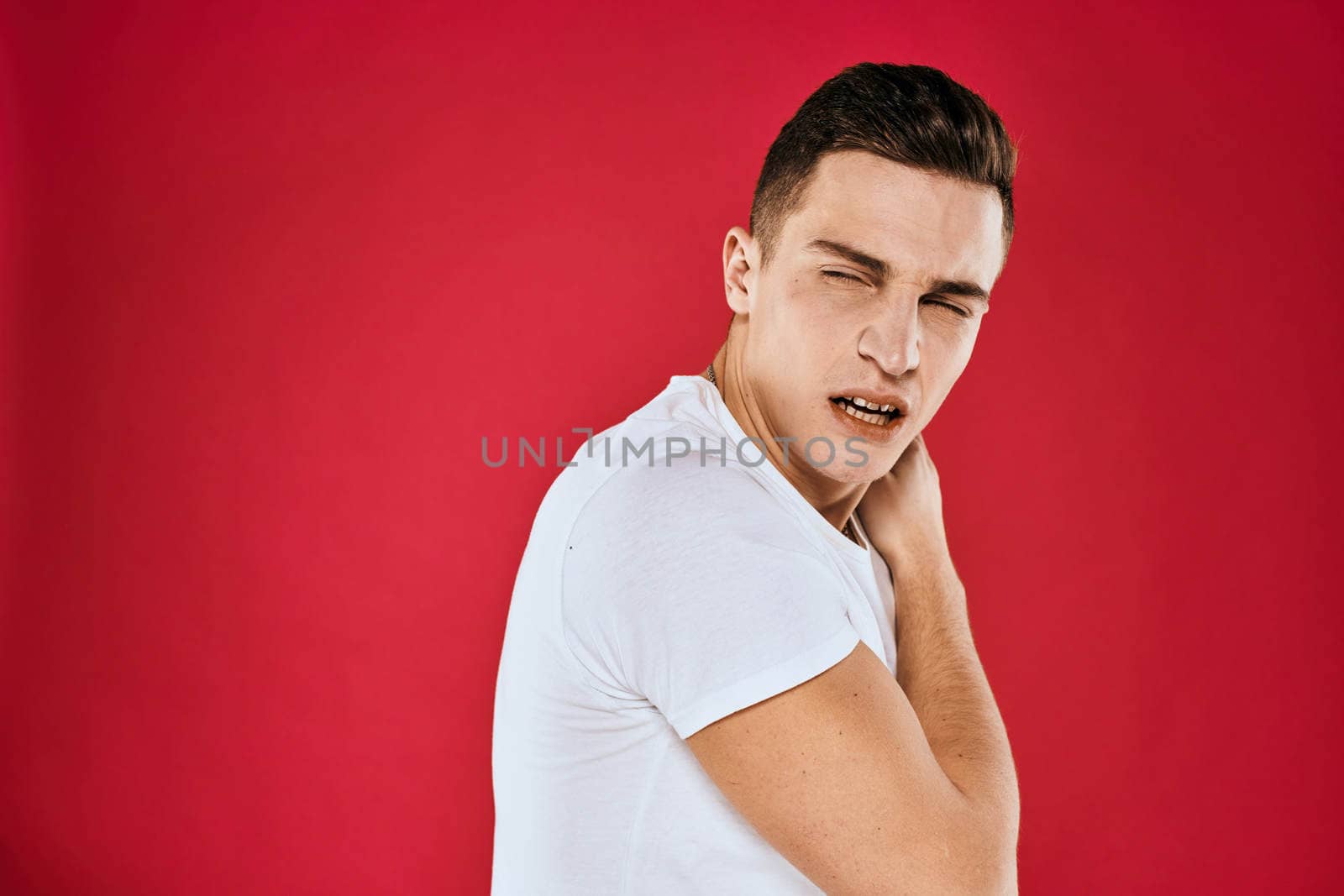 Man in white t-shirt emotions displeased facial expression isolated background. High quality photo