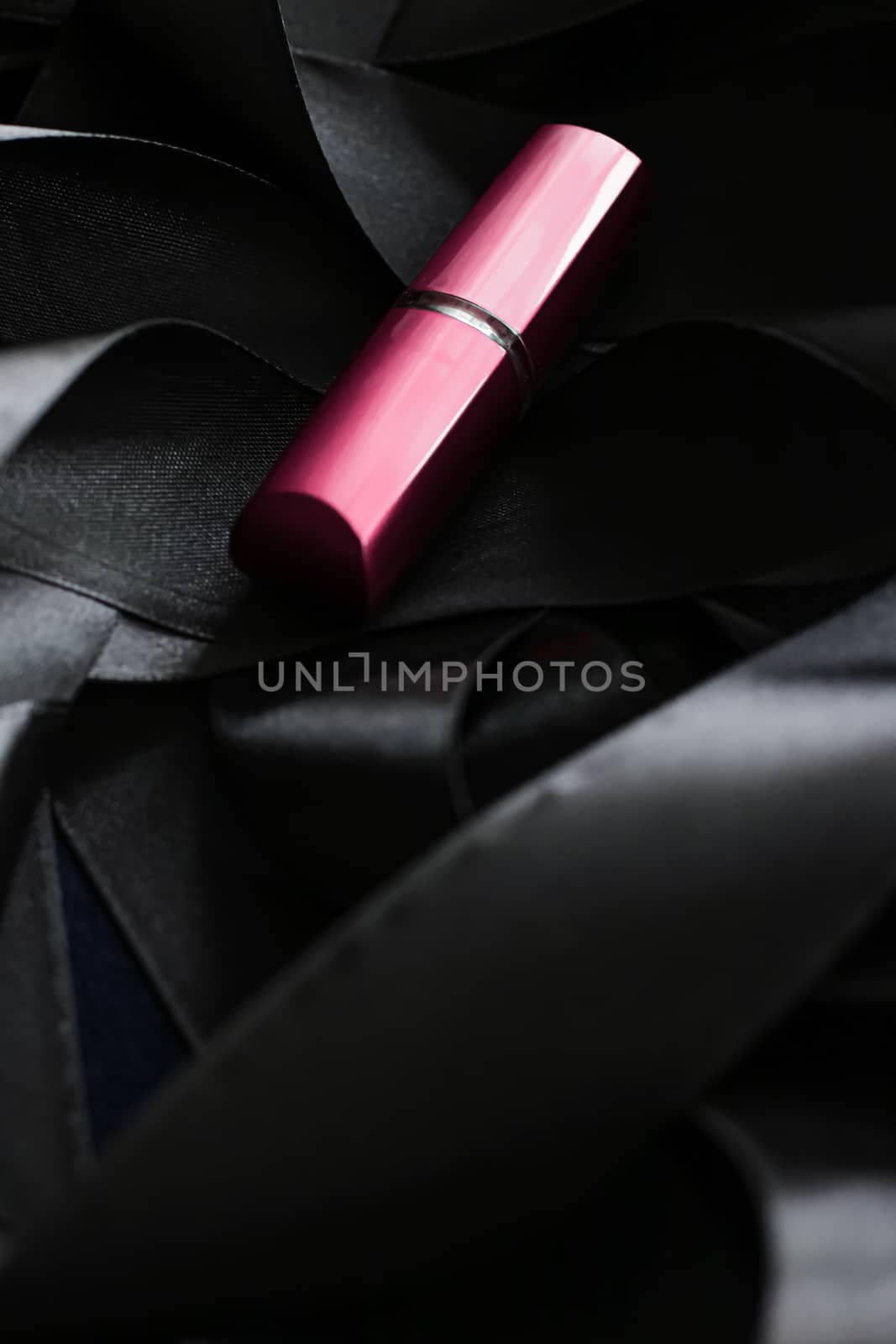 Pink lipstick on black silk background, luxury make-up and beaut by Anneleven