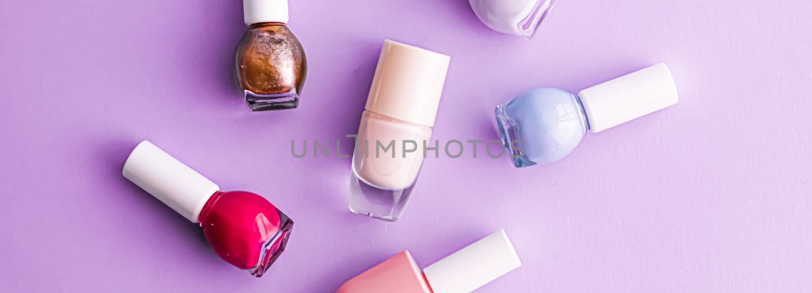 Nail polish bottles on purple background, beauty brand by Anneleven