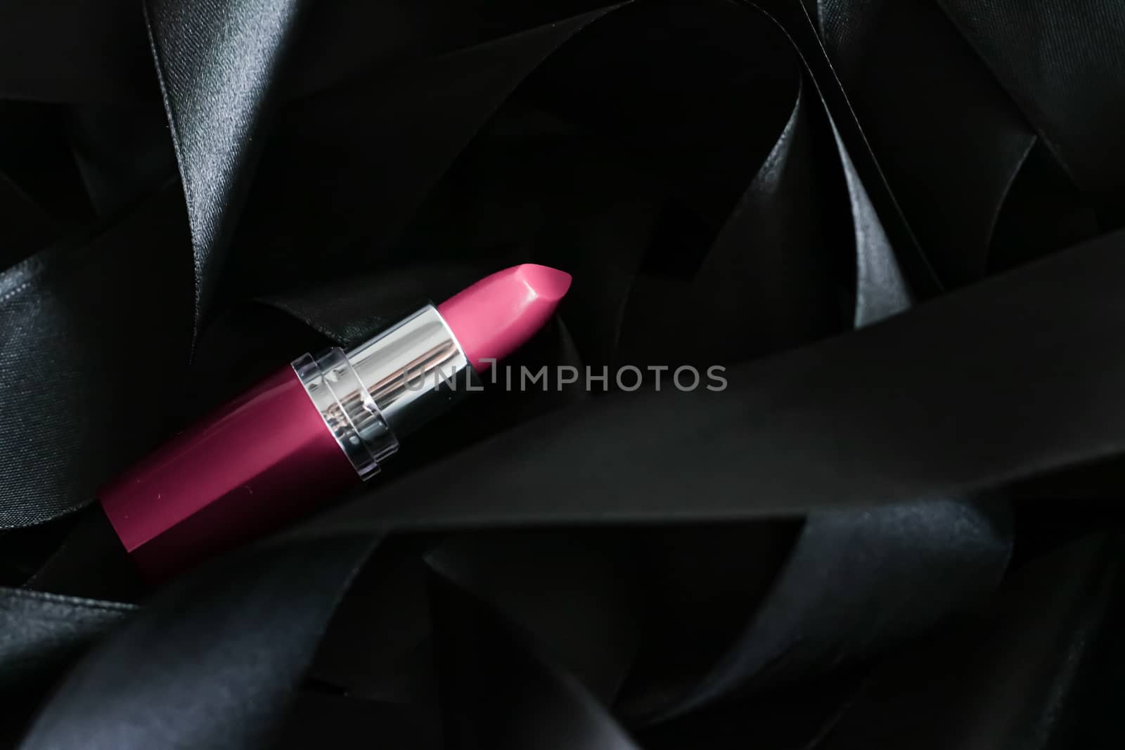 Pink lipstick on black silk background, luxury make-up and beaut by Anneleven