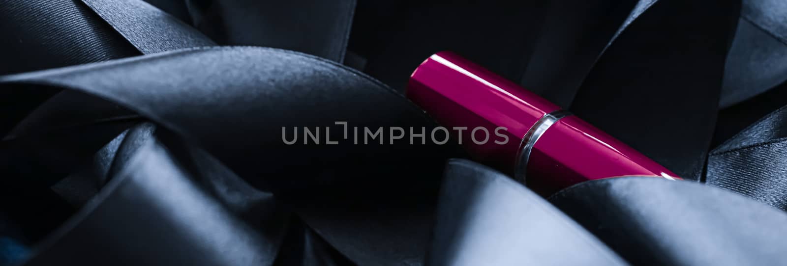 Purple lipstick on black silk background, luxury make-up and beauty cosmetics