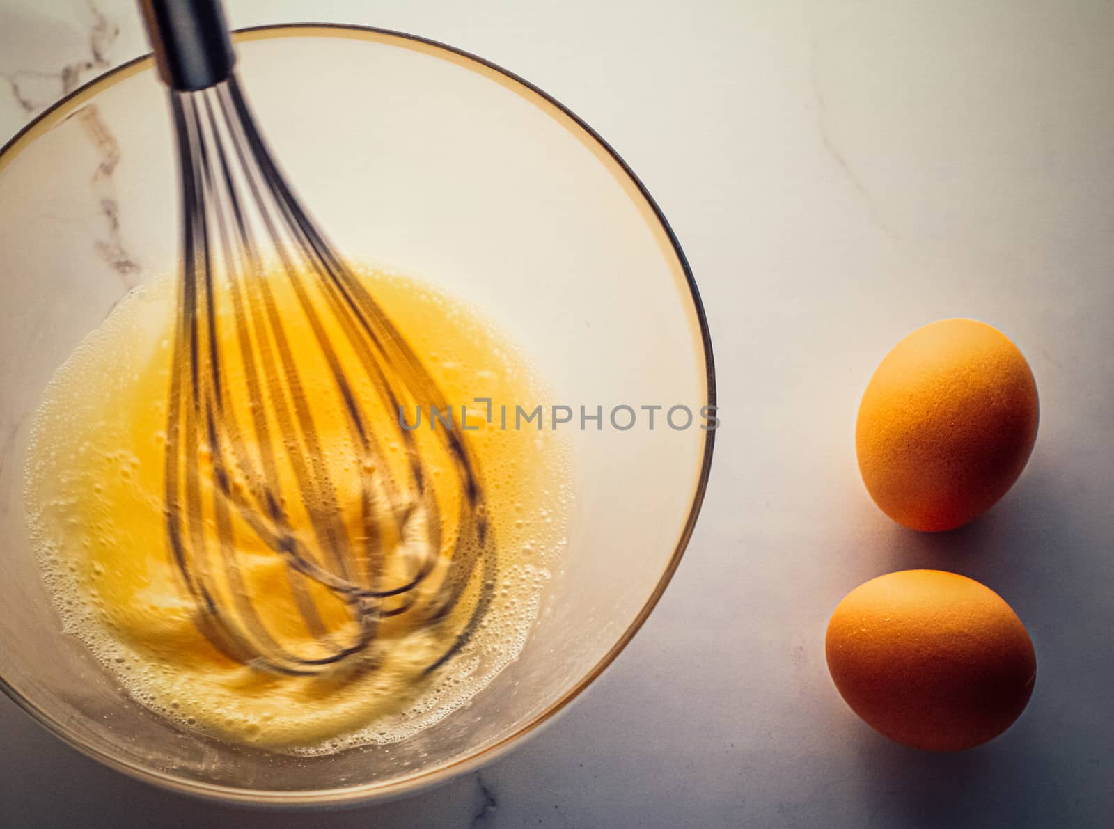 Cooking, meal and diet concept - Making of mixing eggs in bowl on marble table as homemade food flat lay, top view food brand photography flatlay and recipe for cooking blog, menu or cookbook design