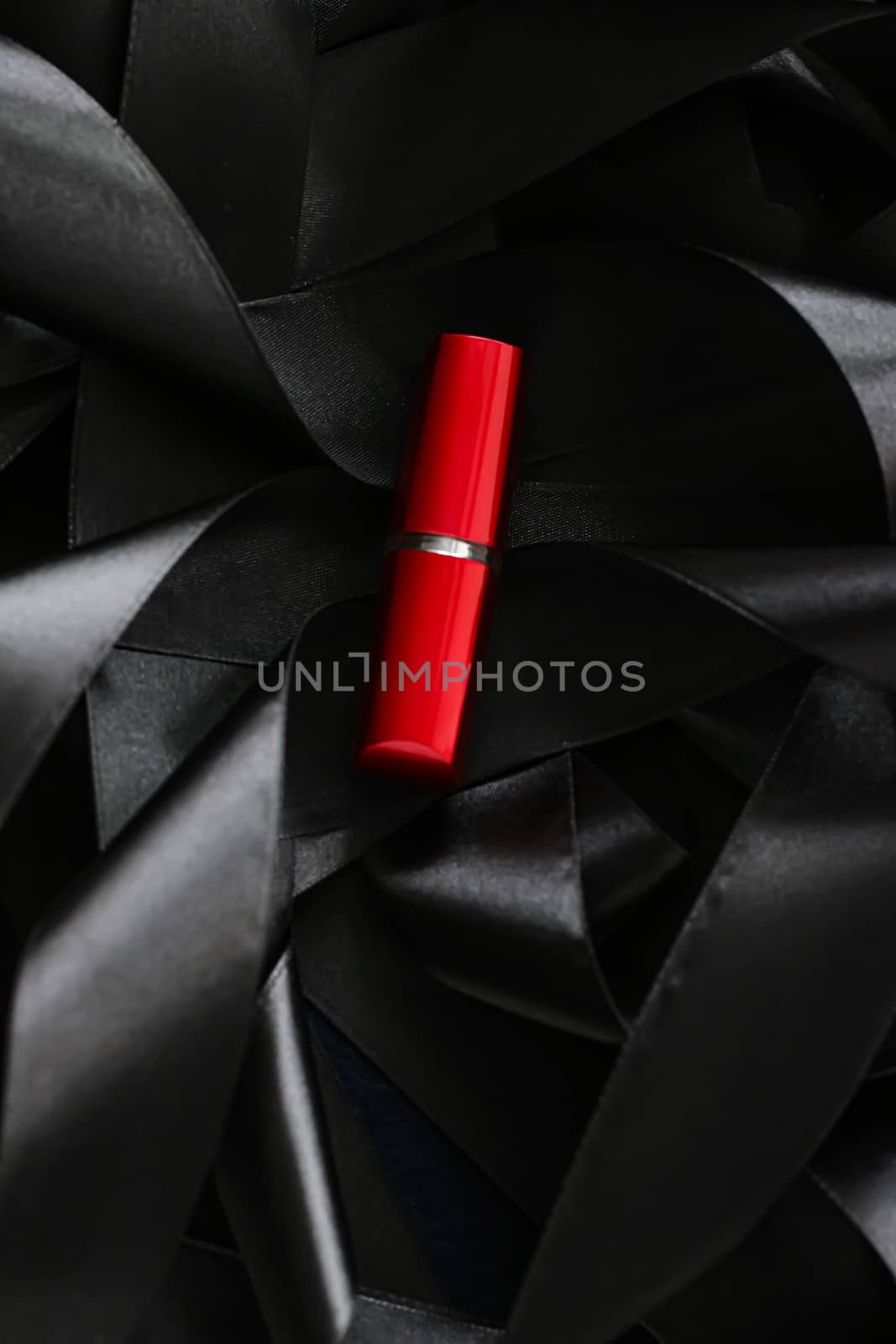 Red lipstick on black silk background, luxury make-up and beauty by Anneleven