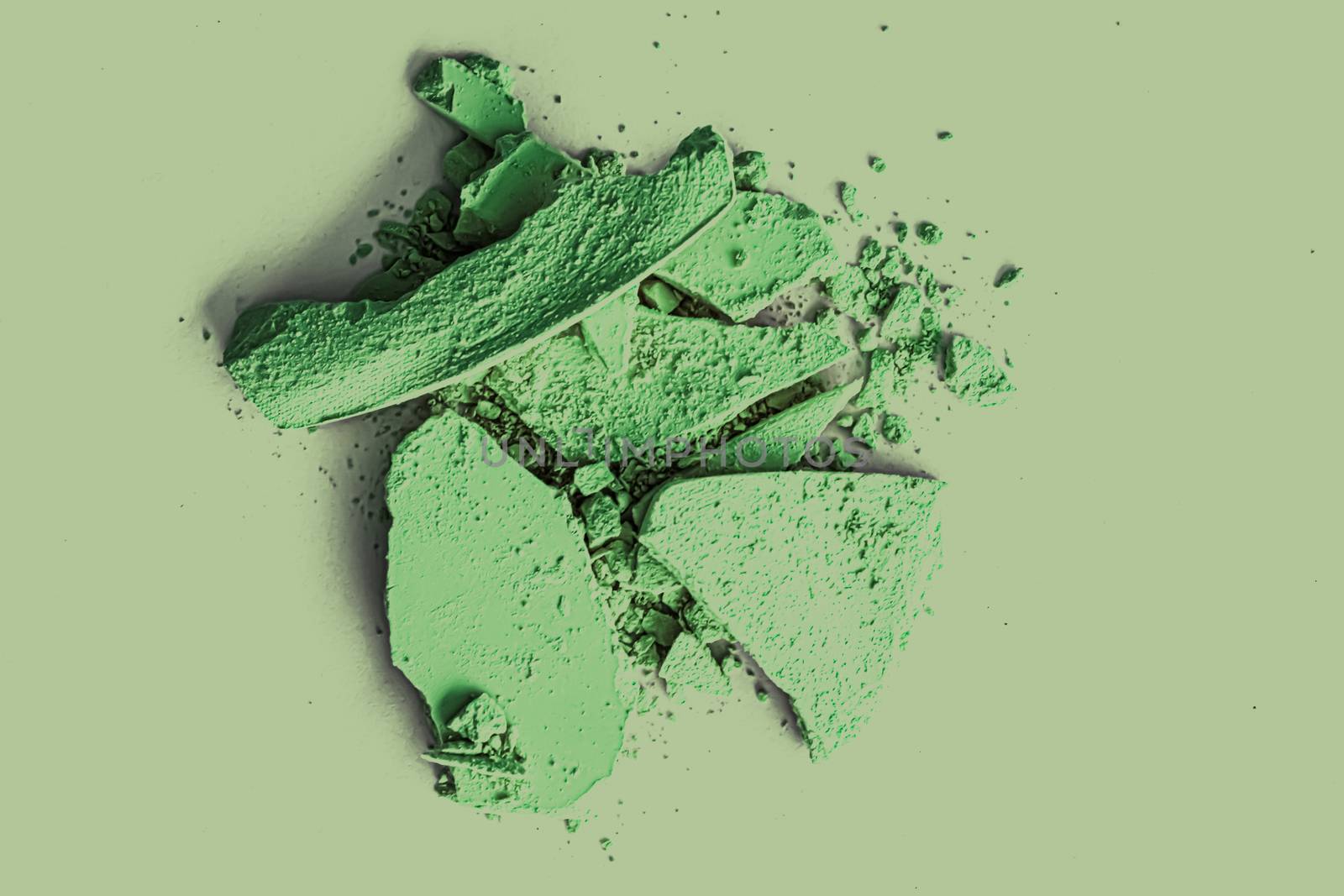 Green eye shadow powder as makeup palette closeup, crushed cosmetics and beauty textures