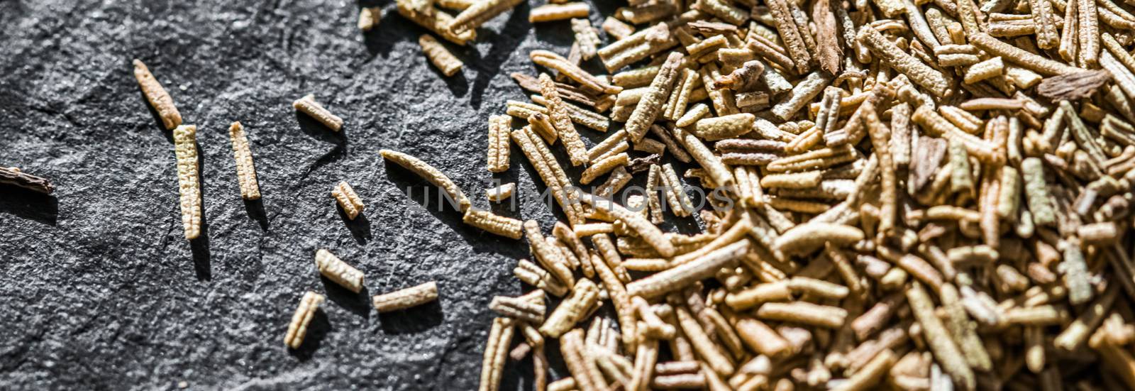 Rosemary closeup on luxury stone background as flat lay, dry food spices and recipe ingredients