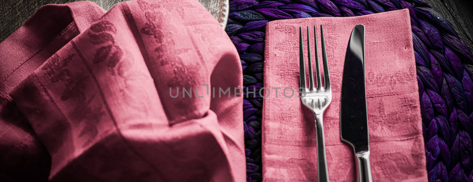 Holiday table setting with pink napkin and silver cutlery, food  by Anneleven