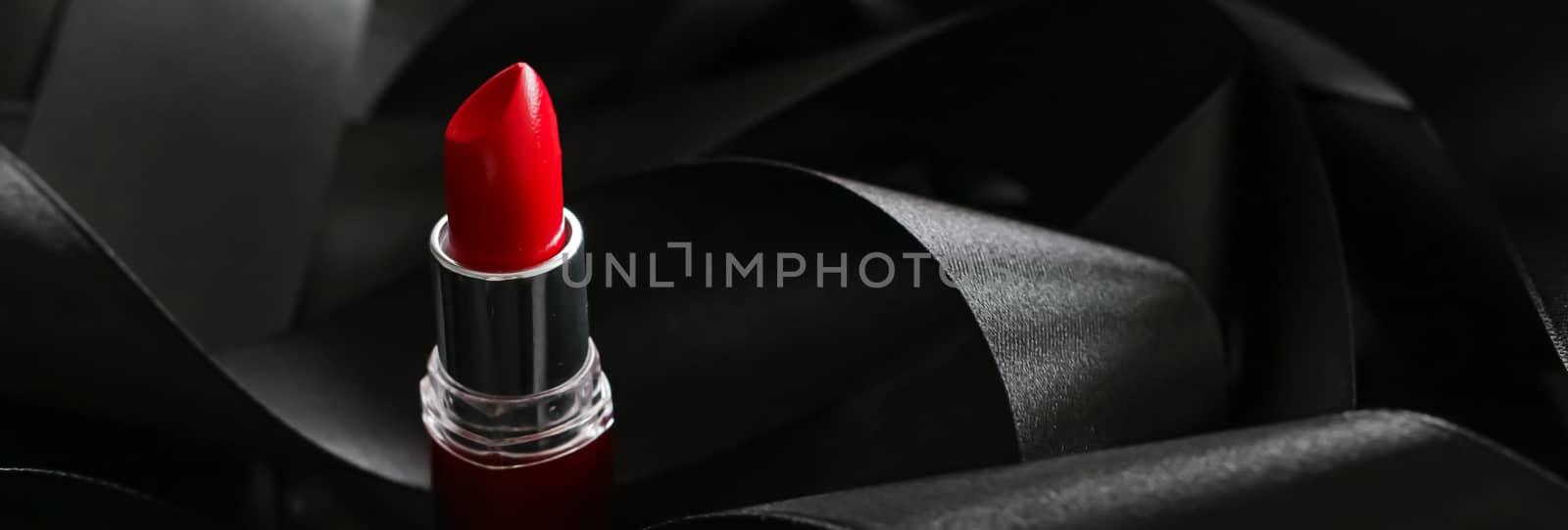 Red lipstick on black silk background, luxury make-up and beauty by Anneleven