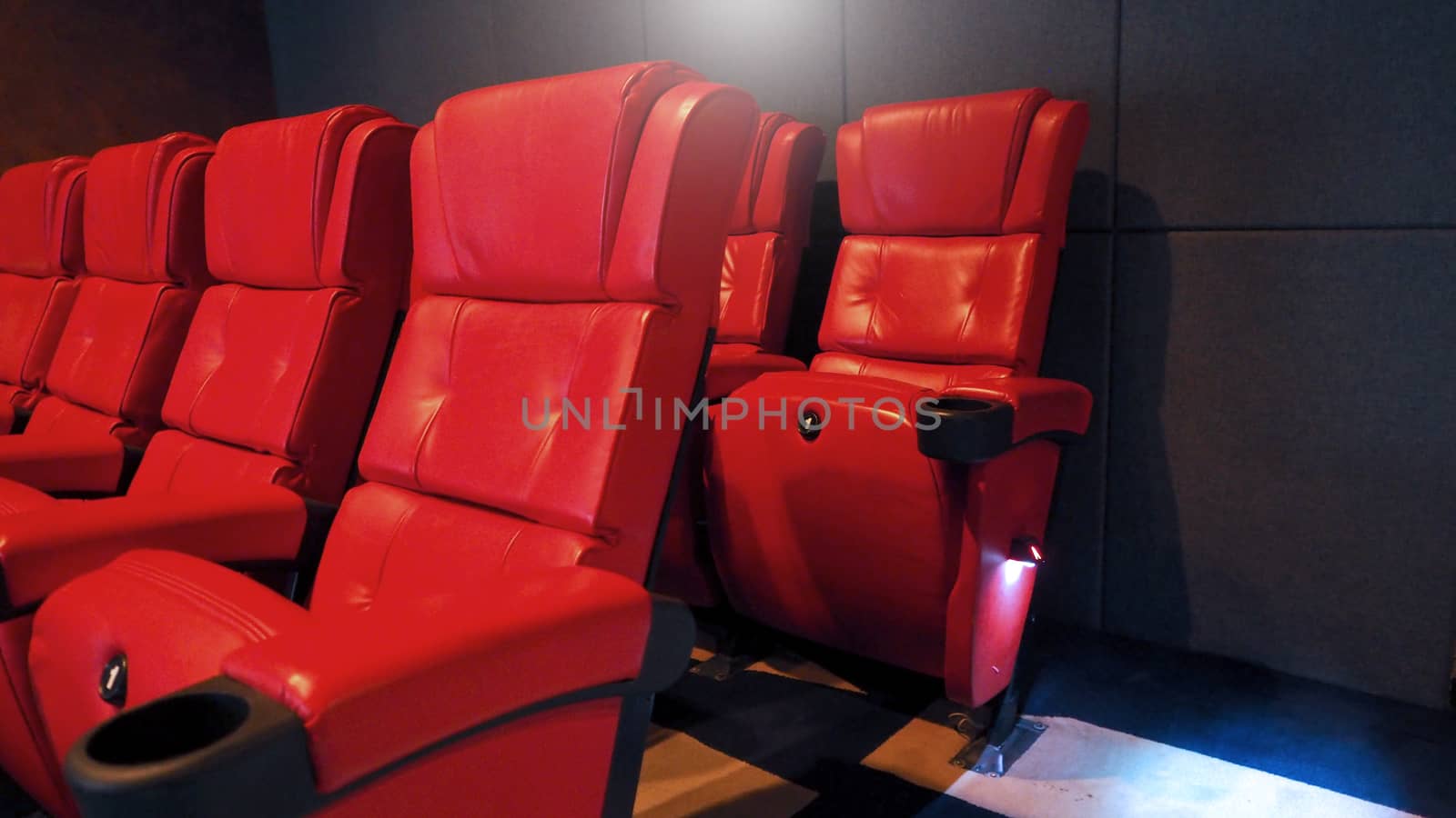 Red color leather movie theater cinema seat chairs which small and old dirty and very bad stingy smell.