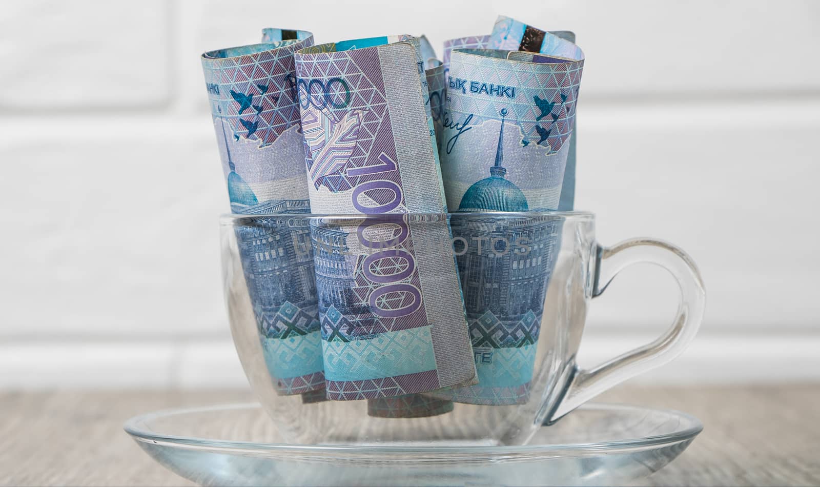 A lot of money Kazakhstan tenge in a cup on the table. The national currency of Kazakhstan. Salary in tenge. Grocery basket, budget savings. Divide the budget. Kazakhstan banks and loans in tenge