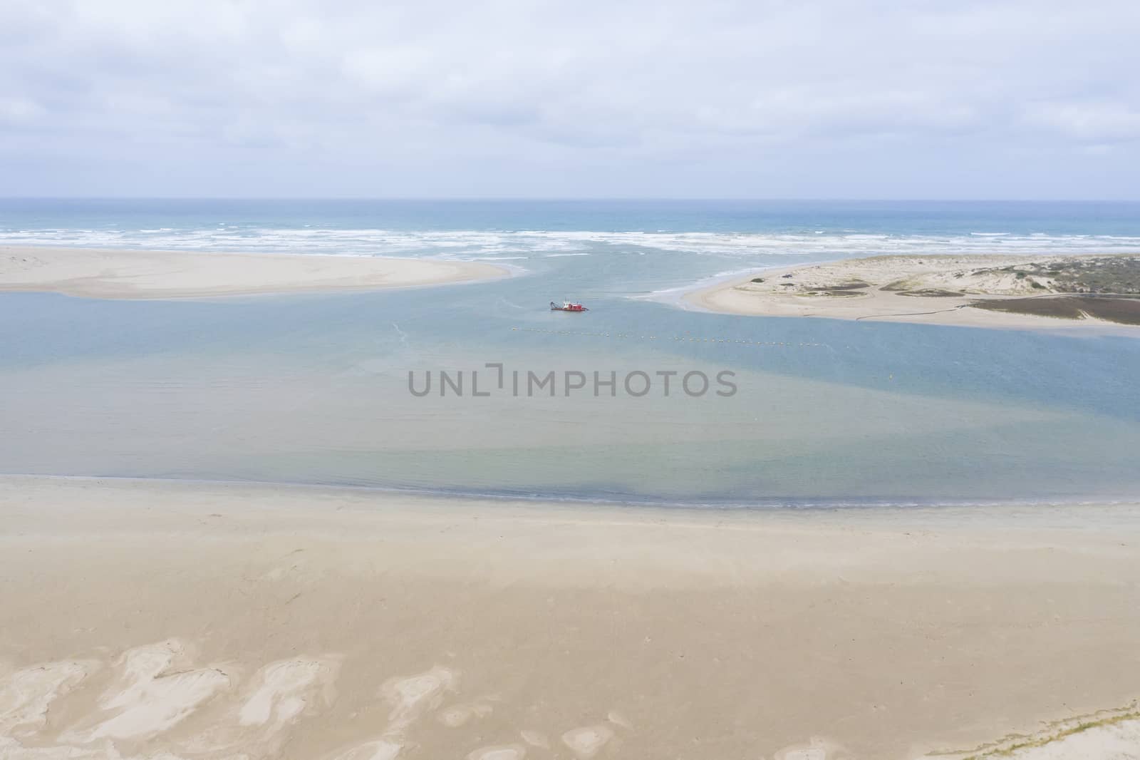 Aerial view of a sand dredger boat at the mouth of the Murray River in South Australia