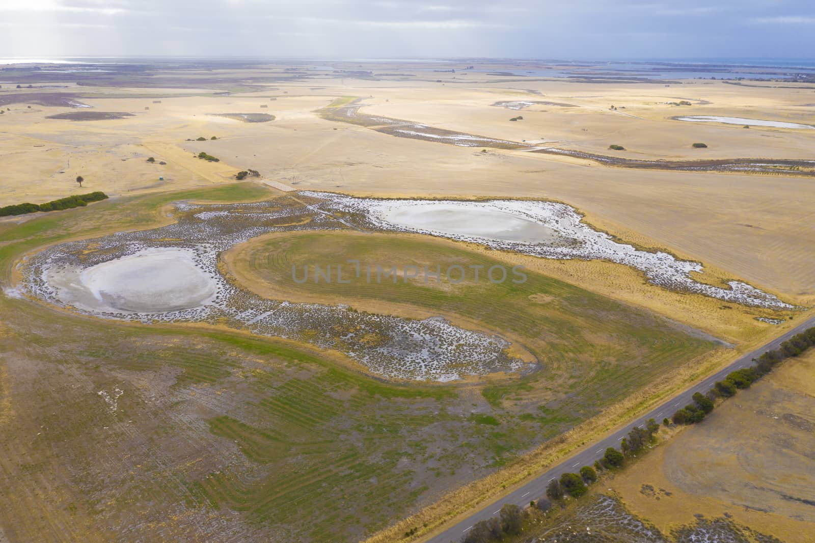 Aerial view of an agricultural irrigation dam affected by drought in regional Australia by WittkePhotos