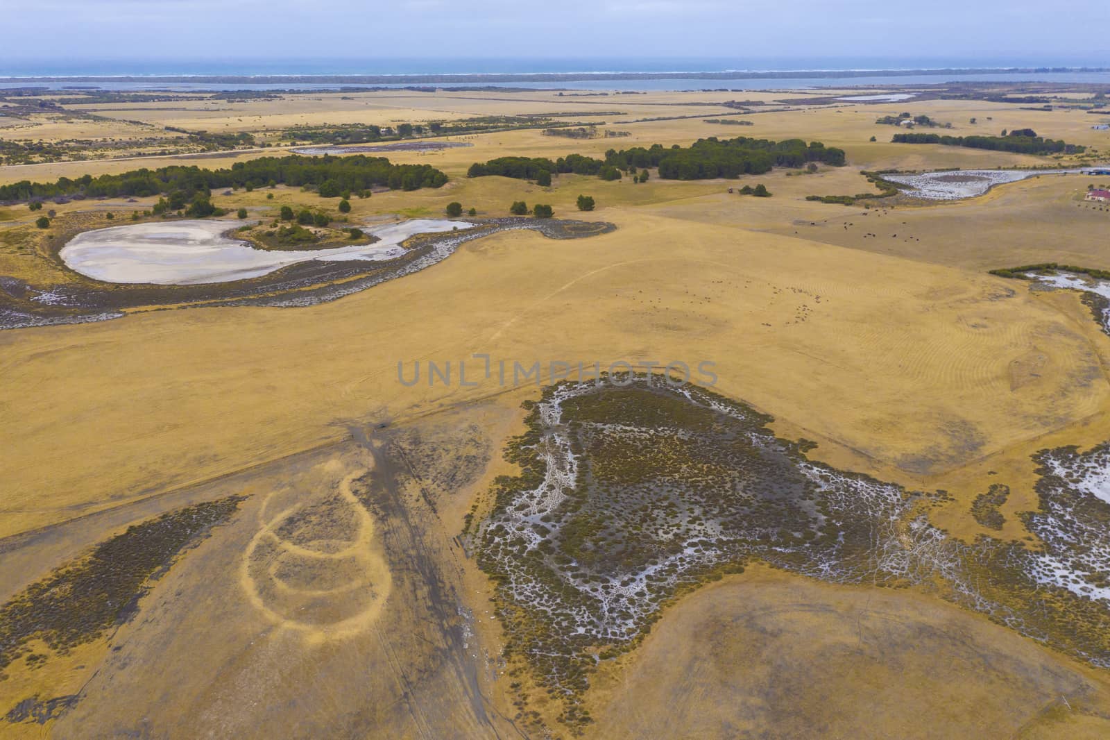 Aerial view of an agricultural irrigation dam affected by drought in regional Australia by WittkePhotos