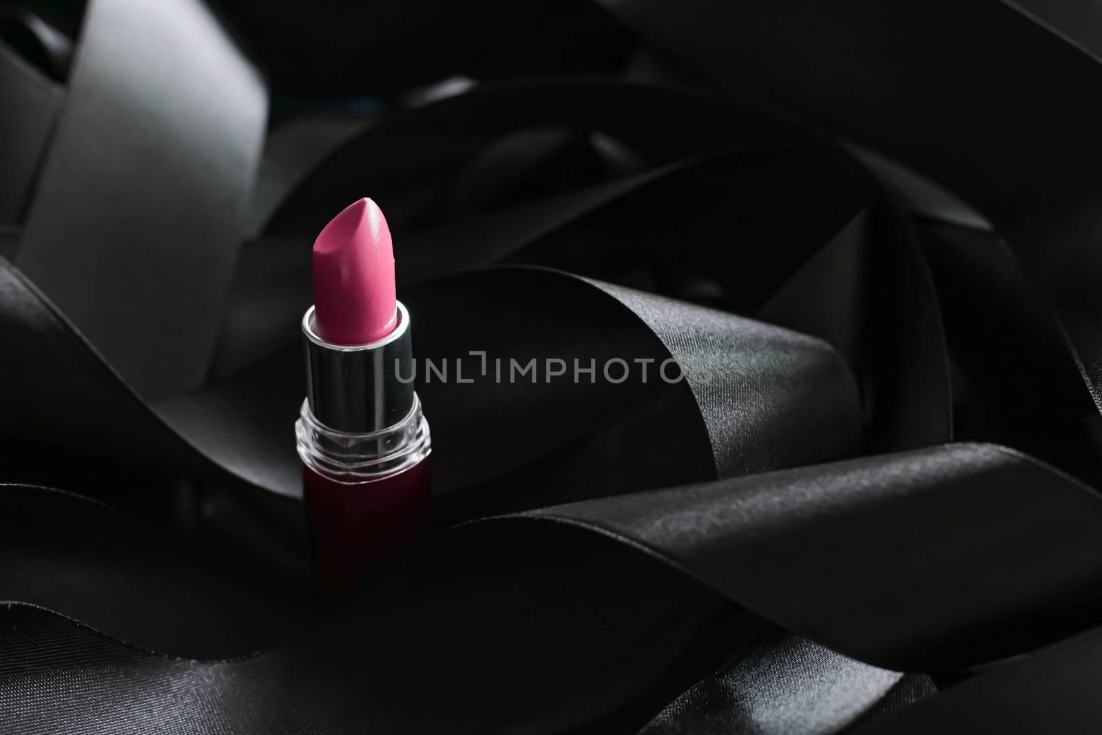 Pink lipstick on black silk background, luxury make-up and beaut by Anneleven