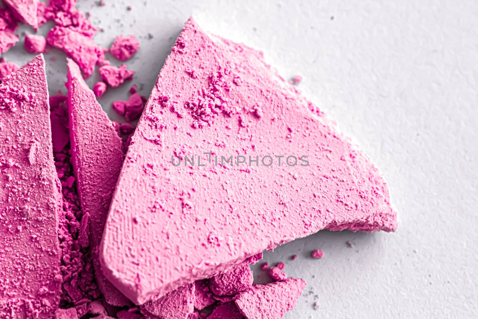 Pink eye shadow powder as makeup palette closeup isolated on white background, crushed cosmetics and beauty textures