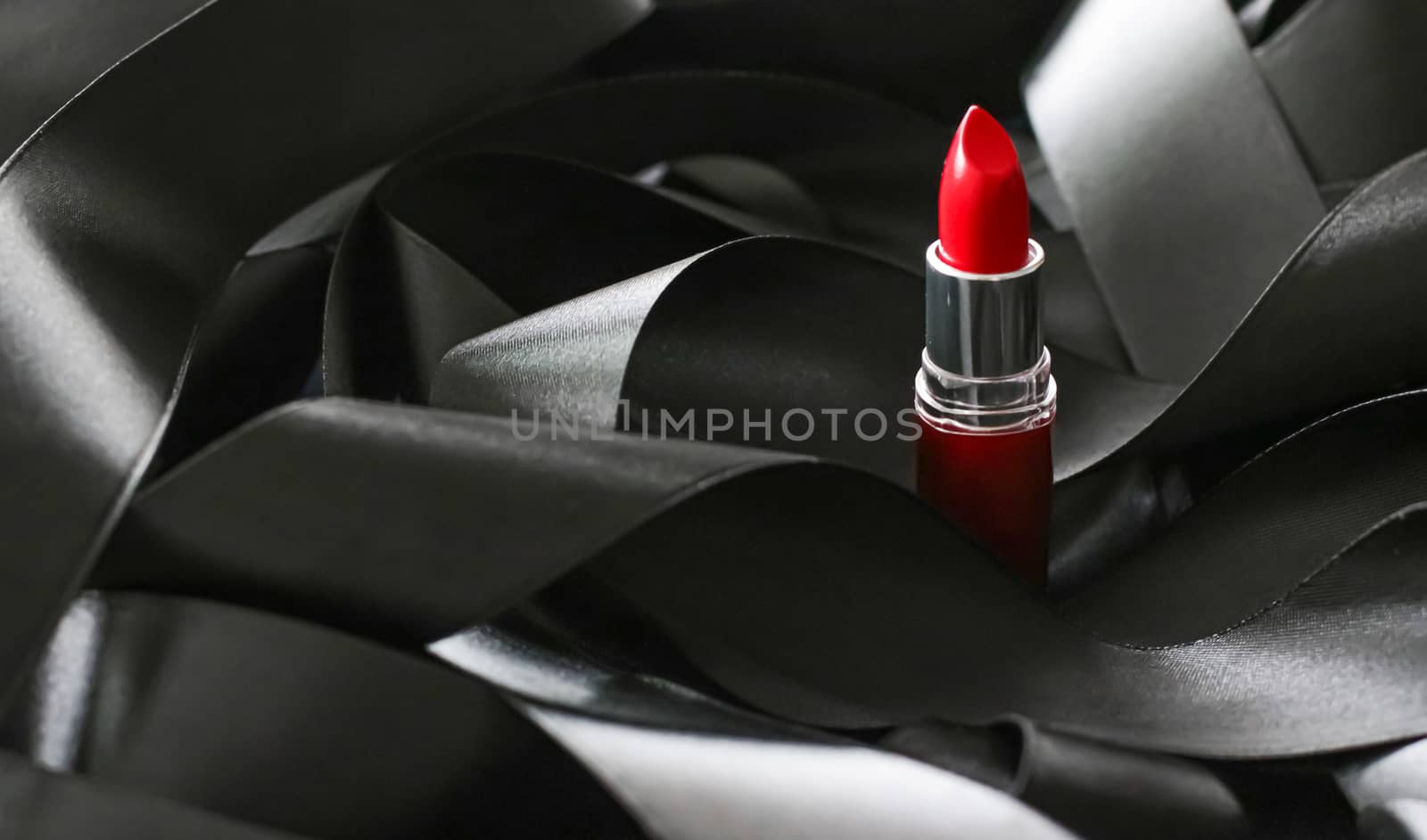 Red lipstick on black silk background, luxury make-up and beauty by Anneleven