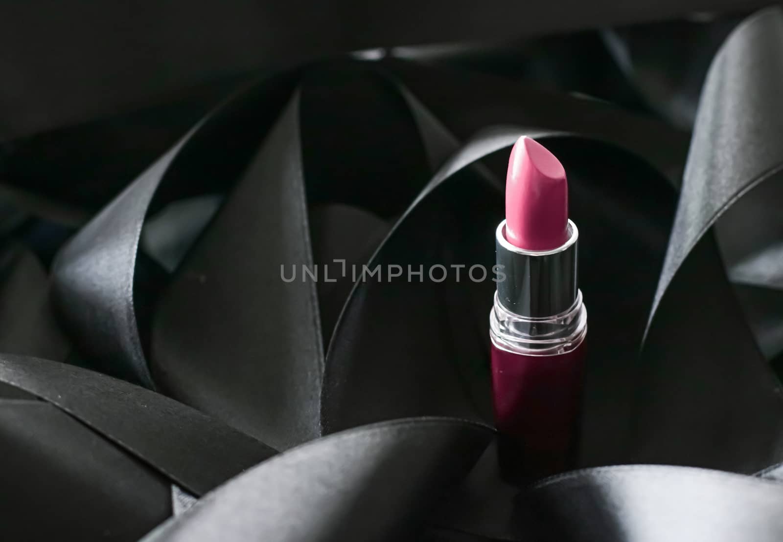 Pink lipstick on black silk background, luxury make-up and beaut by Anneleven