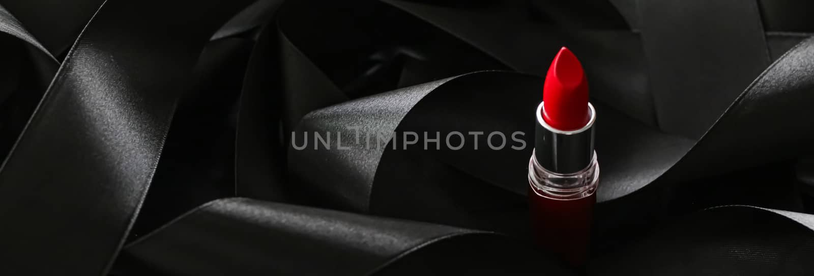 Red lipstick on black silk background, luxury make-up and beauty cosmetics