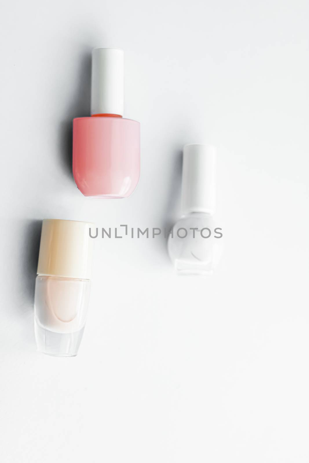 Nail polish bottles on white background, beauty branding