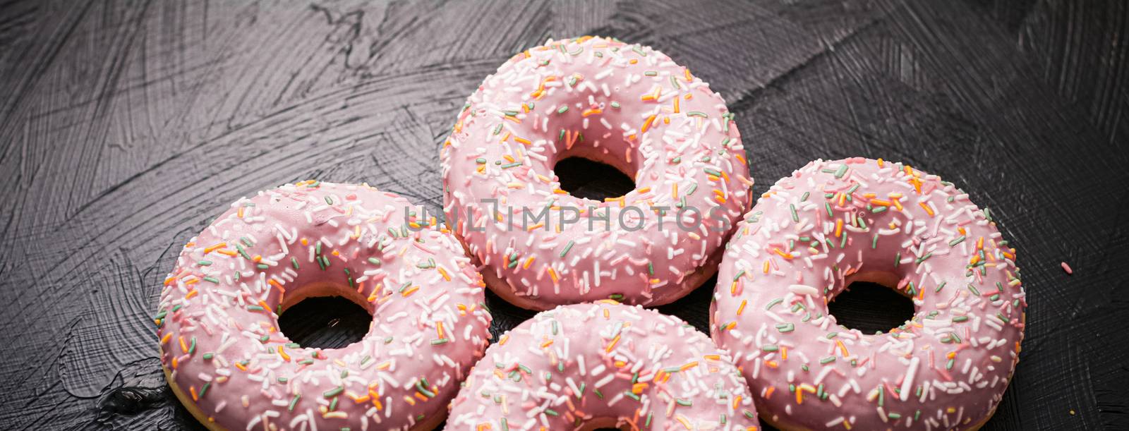 Bakery, branding and cafe concept - Frosted sprinkled donuts, sweet pastry dessert on rustic wooden background, doughnuts as tasty snack, top view food brand flat lay for blog, menu or cookbook design