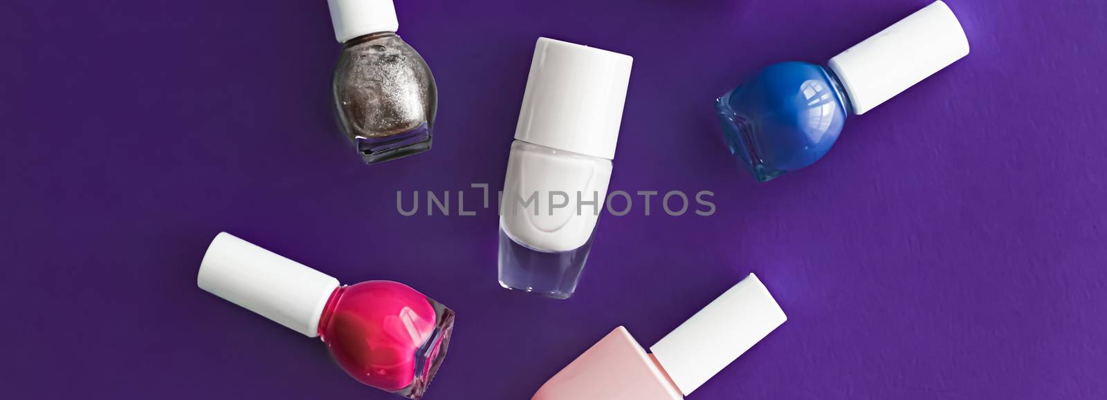 Nail polish bottles on dark purple background, beauty brand by Anneleven