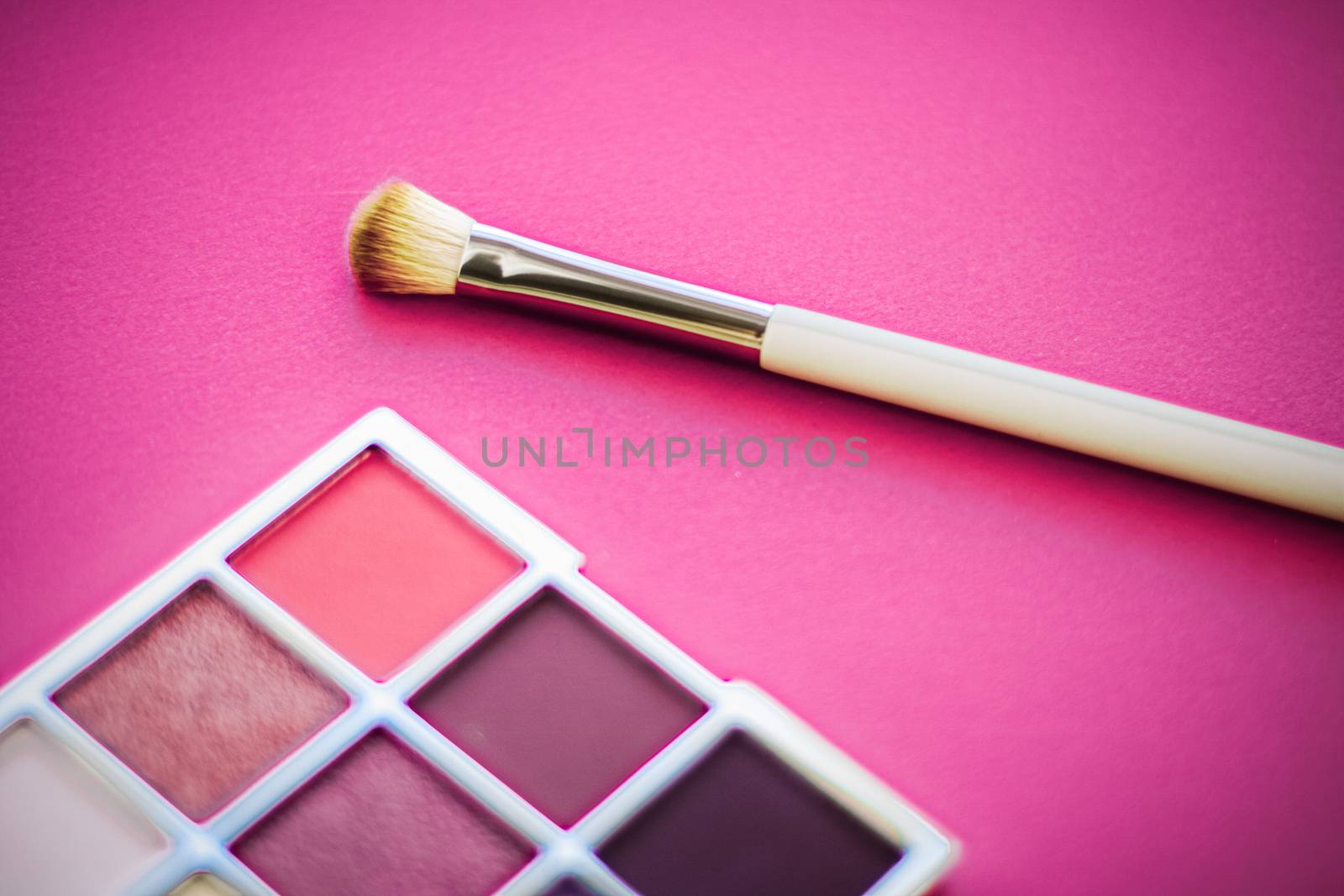 Cosmetic branding, mua and girly concept - Eyeshadow palette and make-up brush on rose background, eye shadows cosmetics product for luxury beauty brand promotion and holiday fashion blog design