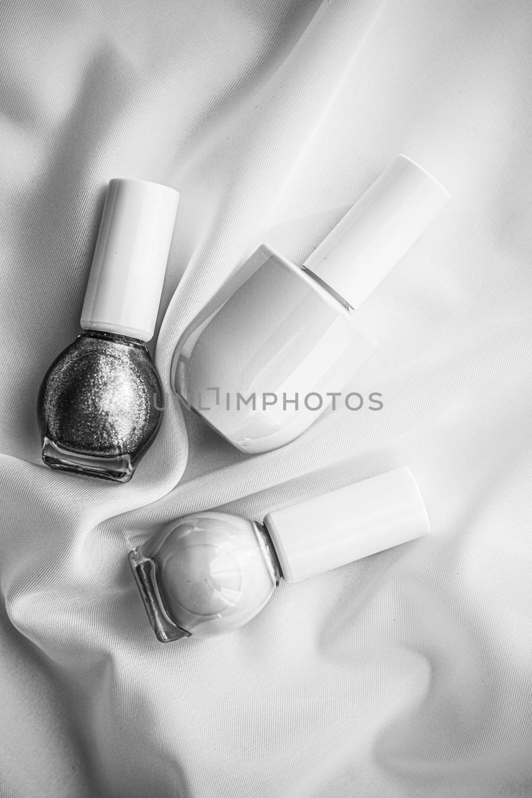 Cosmetic branding, salon and glamour concept - Nail polish bottles on silk background, french manicure products and nailpolish make-up cosmetics for luxury beauty brand and holiday flatlay art design