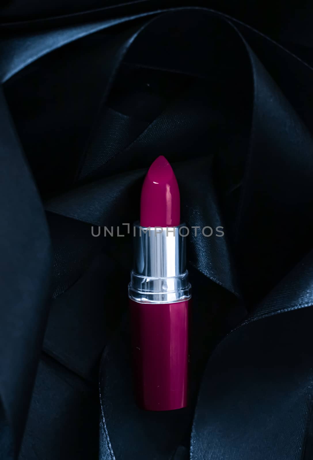 Purple lipstick on black silk background, luxury make-up and beauty cosmetics