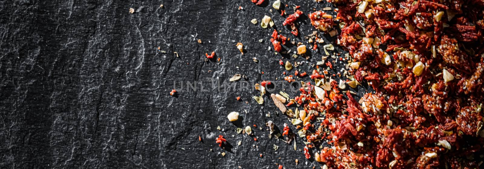 Dried tomato and chili pepper closeup on luxury stone background as flat lay, dry food spices and recipe ingredients