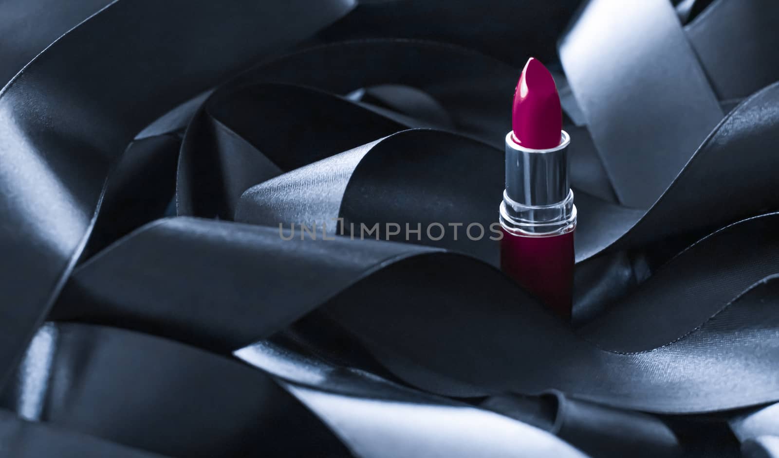 Purple lipstick on black silk background, luxury make-up and beauty cosmetics