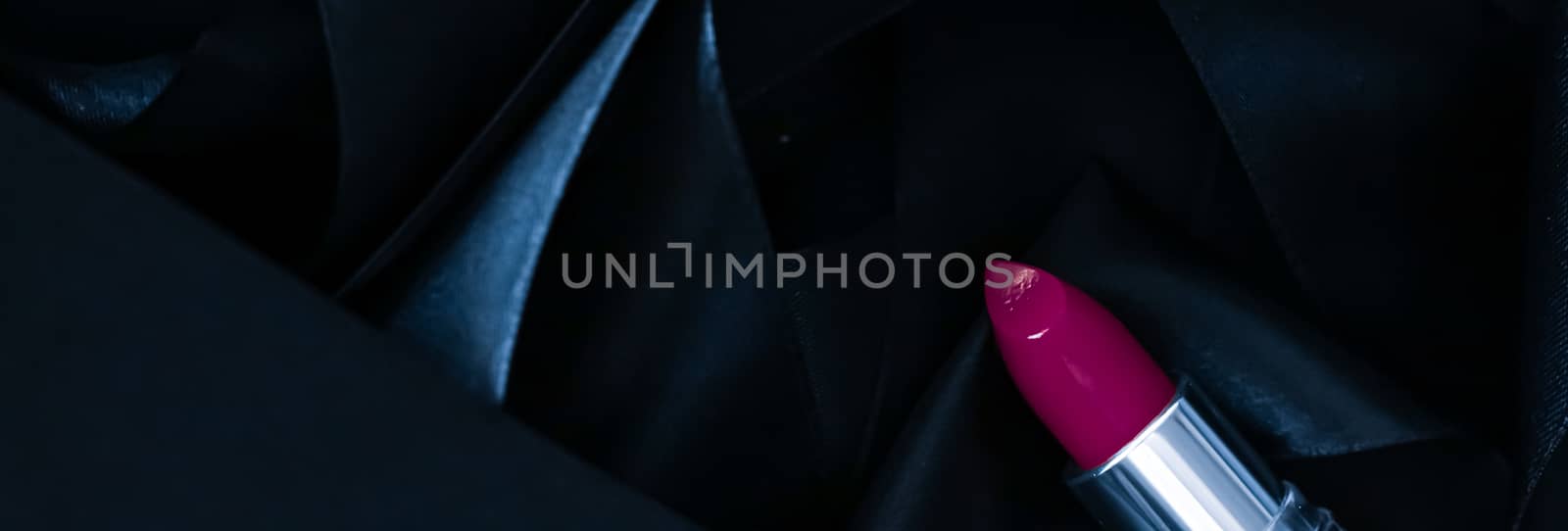 Purple lipstick on black silk background, luxury make-up and beauty cosmetics