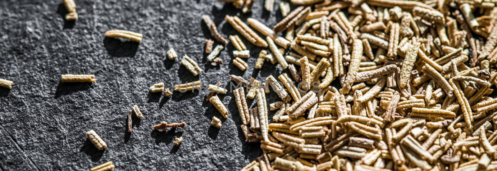 Rosemary closeup on luxury stone background as flat lay, dry food spices and recipe ingredients