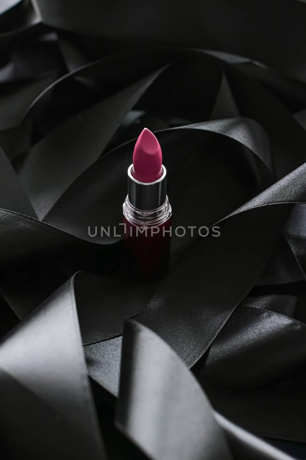 Pink lipstick on black silk background, luxury make-up and beauty cosmetics