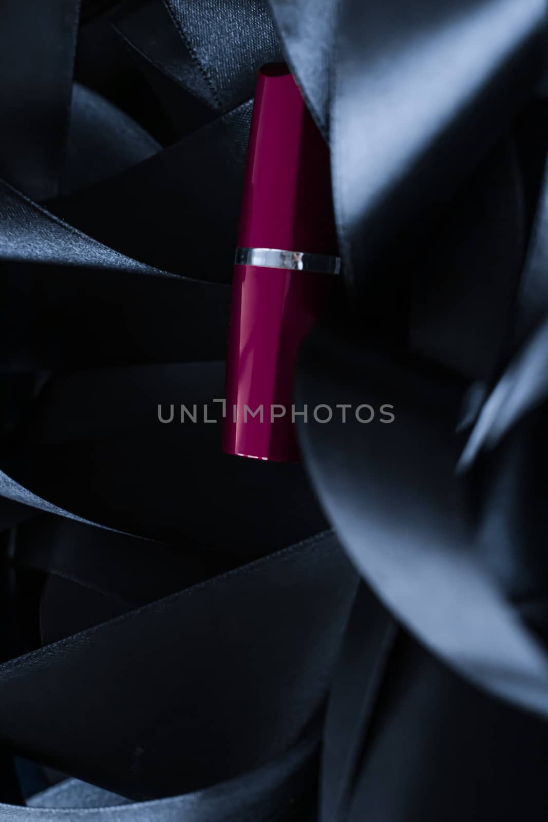 Purple lipstick on black silk background, luxury make-up and beauty cosmetics