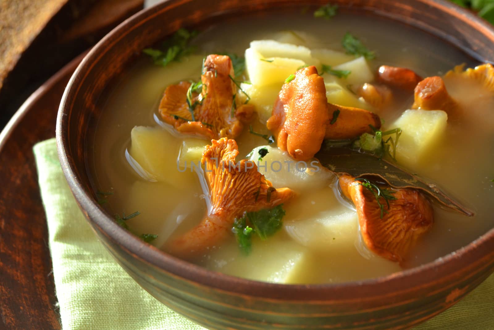 Background of cream soup with chanterelles and fresh thyme. Close up