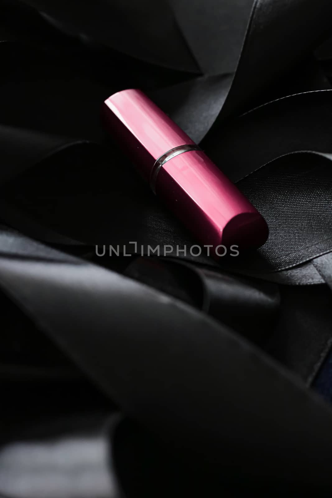 Pink lipstick on black silk background, luxury make-up and beauty cosmetics