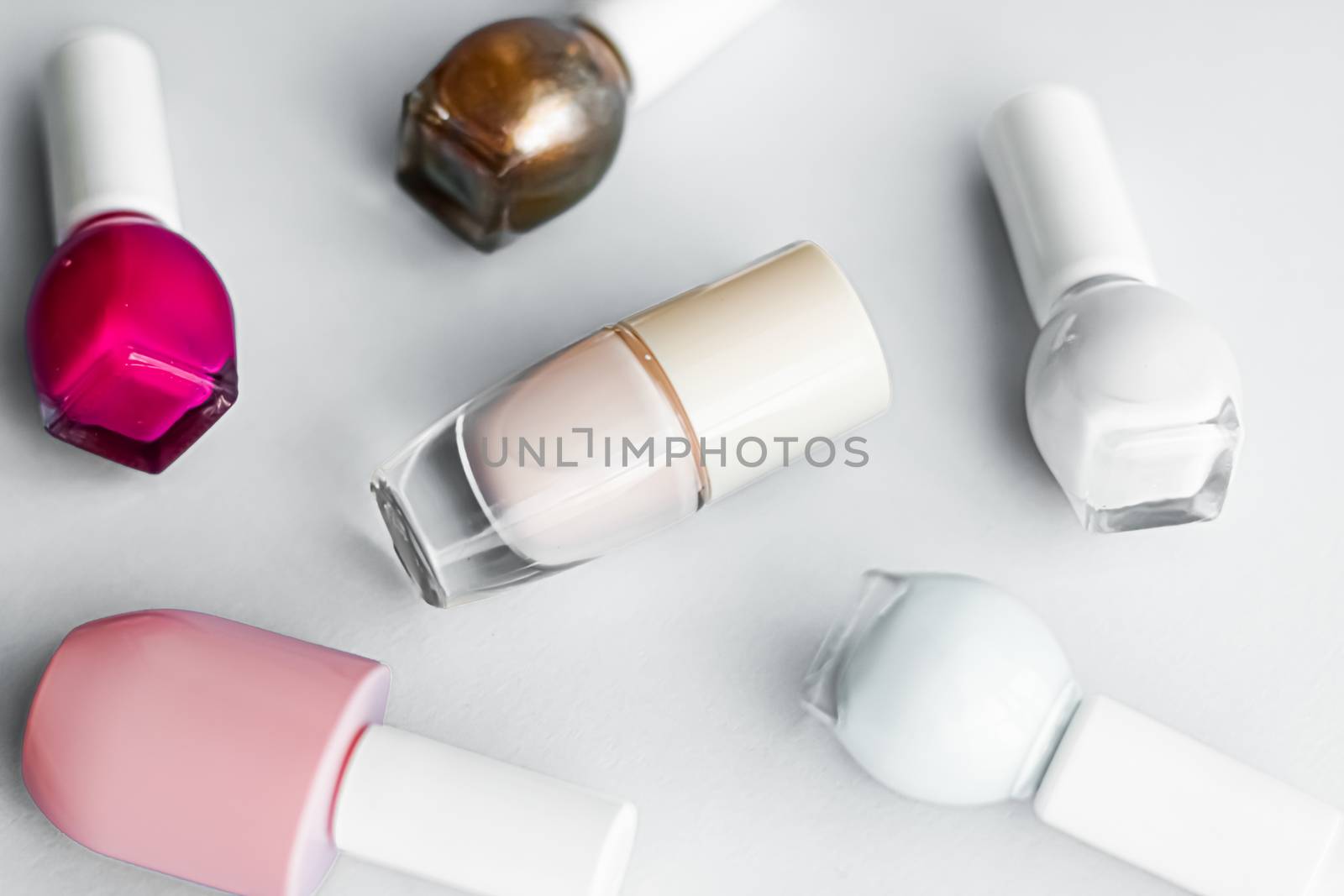 Nail polish bottles on white background, beauty branding