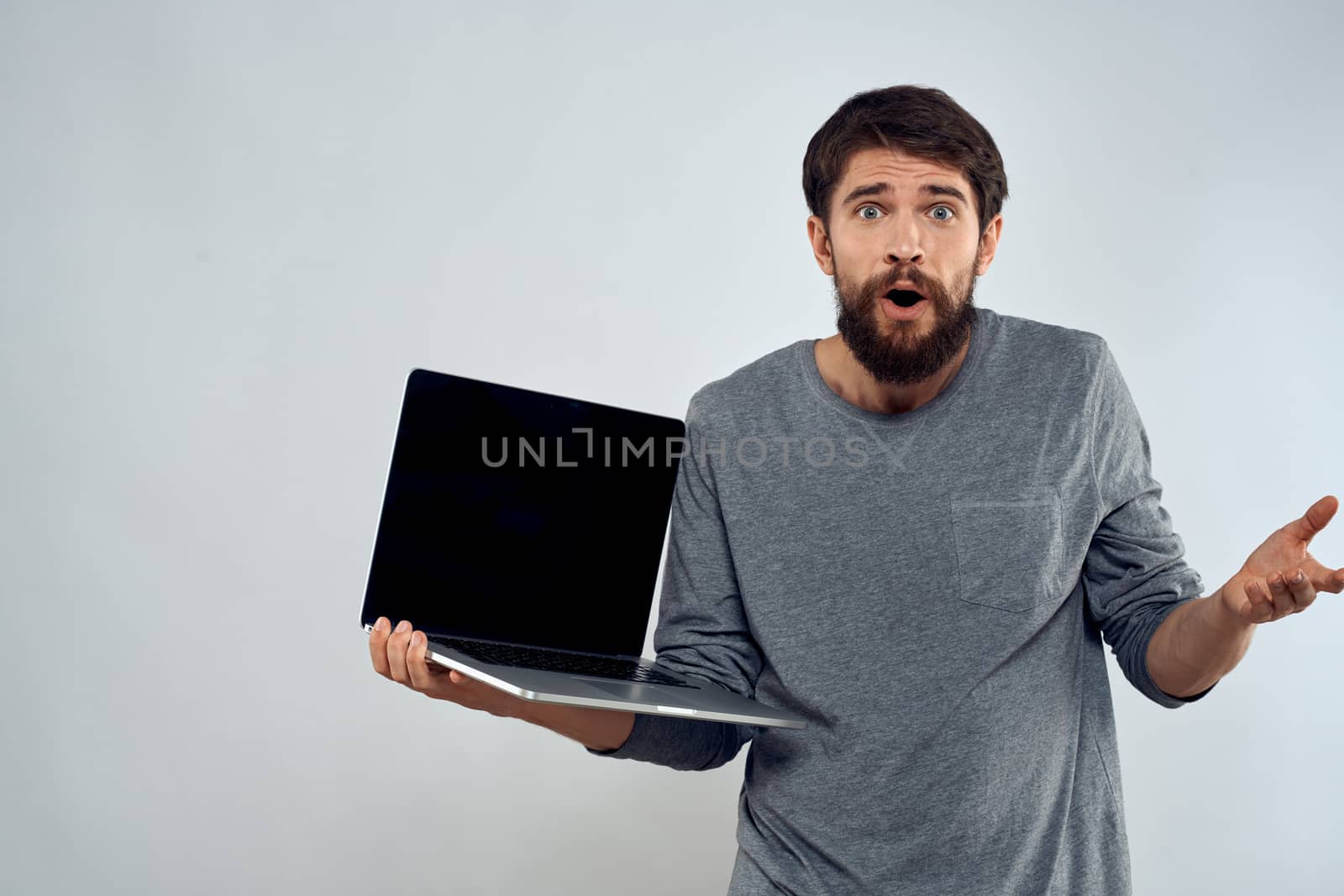 man holding laptop technology internet work communication light background by SHOTPRIME