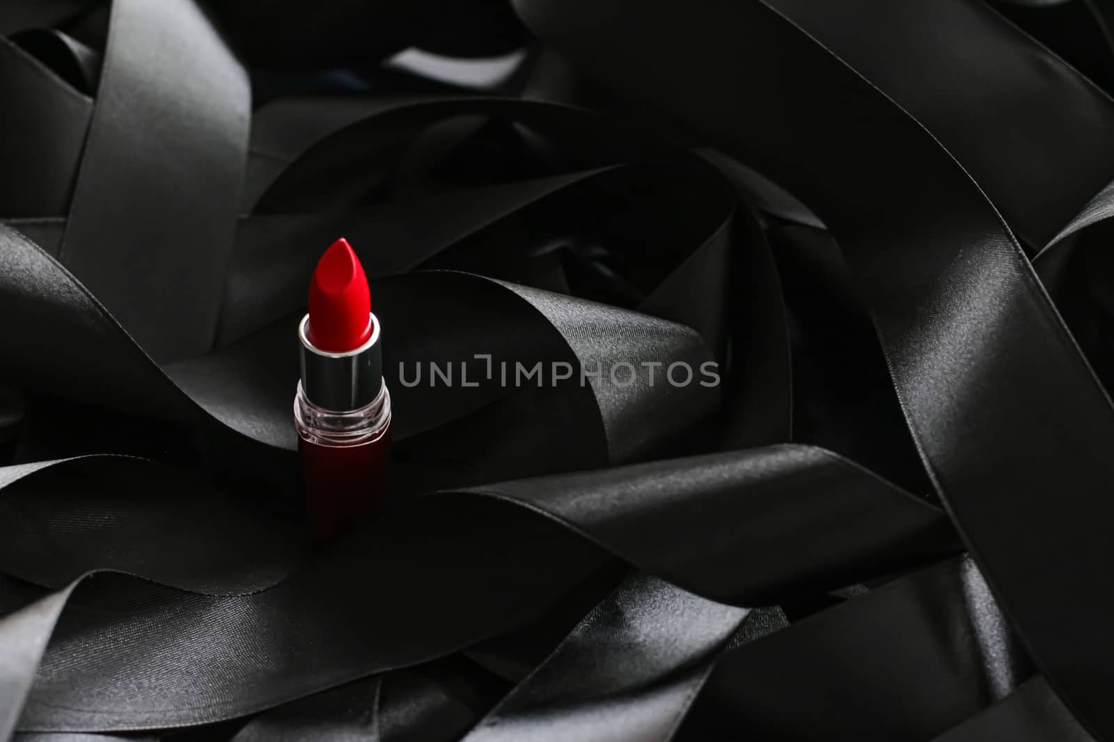 Red lipstick on black silk background, luxury make-up and beauty by Anneleven