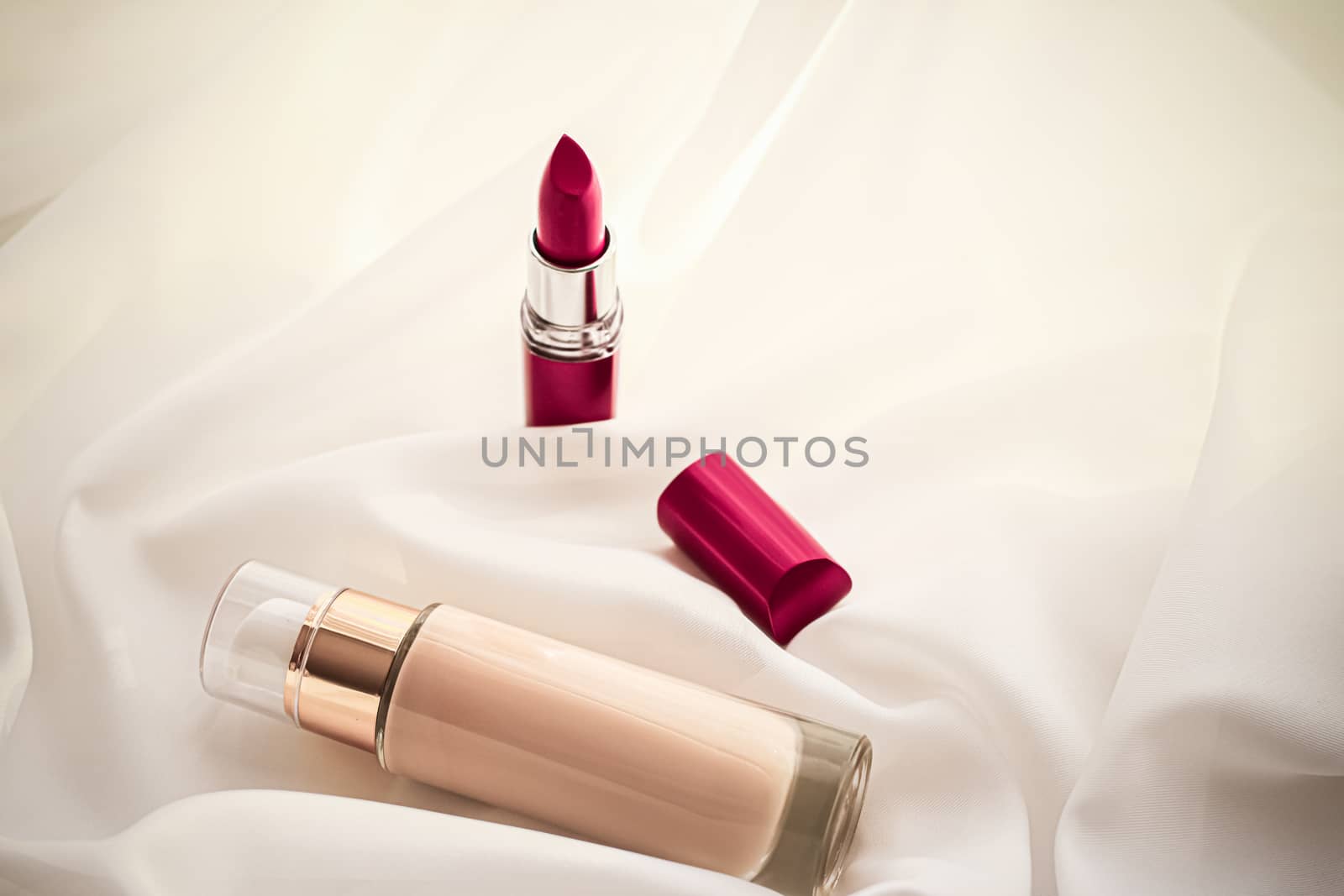 Cosmetic branding, glamour and skincare concept - Beige tonal cream bottle make-up fluid foundation base and red lipstick on silk background, cosmetics products as luxury beauty brand holiday design