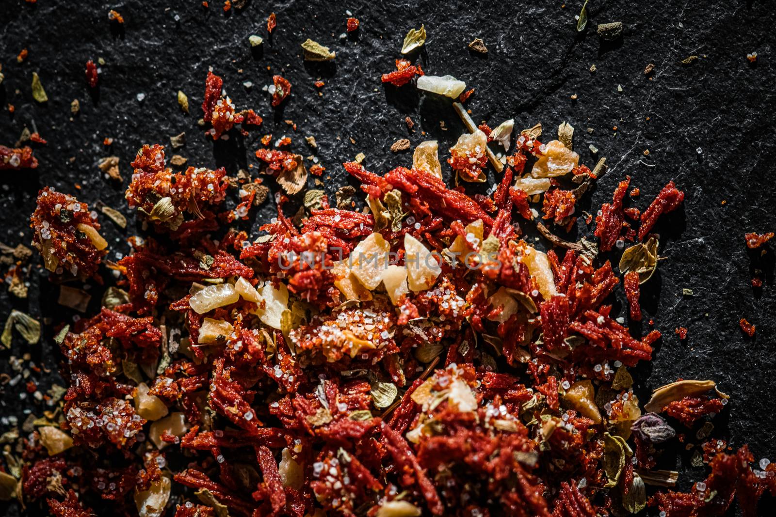 Dried tomato and chili pepper closeup on luxury stone background as flat lay, dry food spices and recipe ingredients