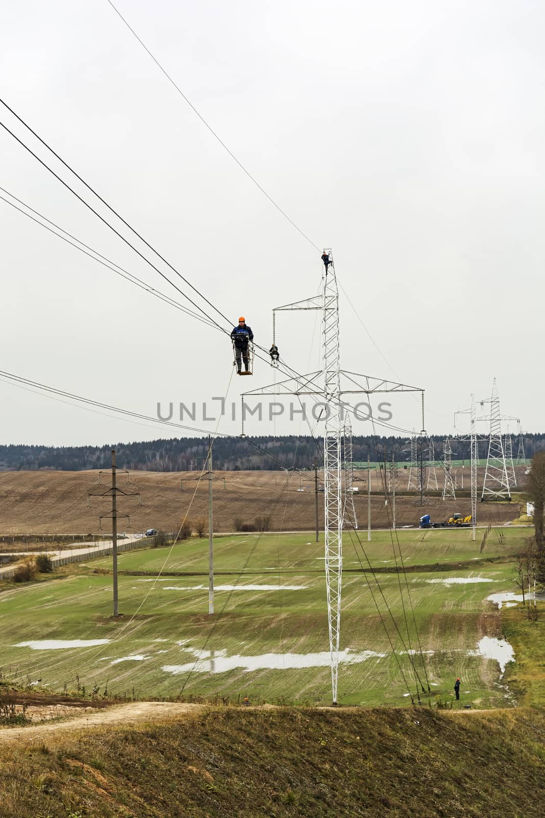 Belarus, Minsk – 09 Nov 2016: Workers inspect the wires of high voltage transmission lines
