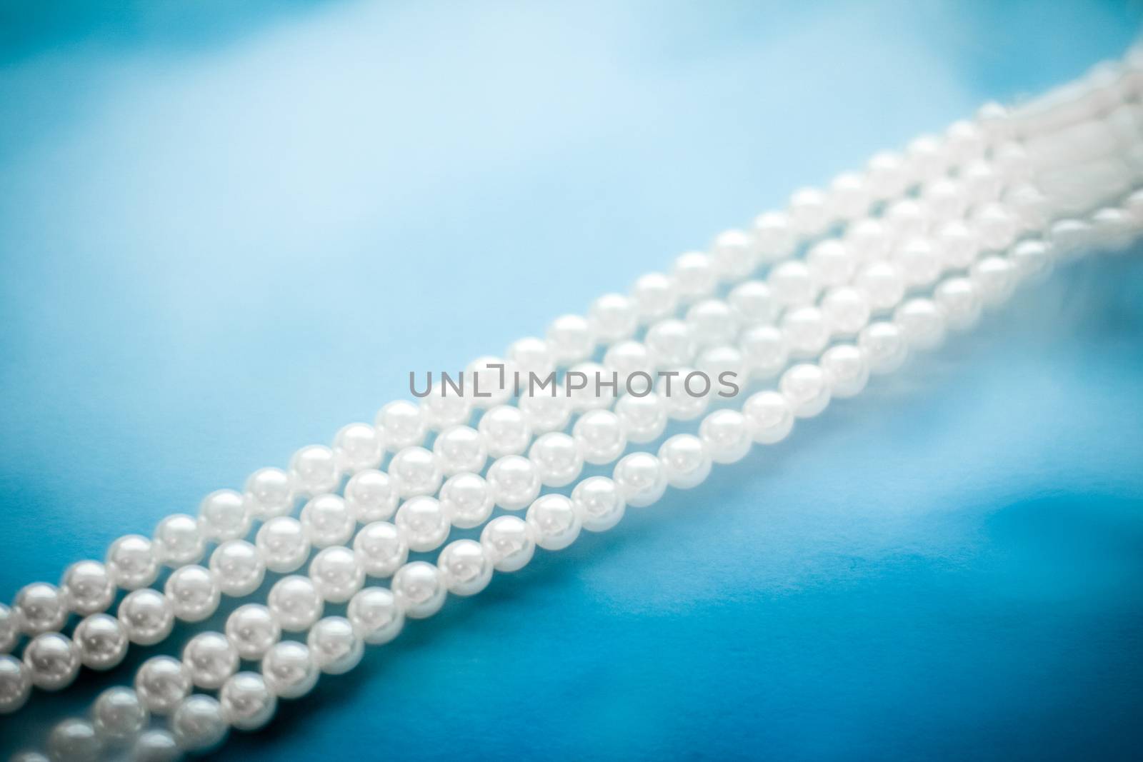 Jewelry, branding and gems concept - Coastal jewellery fashion, pearl necklace under blue water background, glamour style present and chic gift for luxury jewelery brand, holiday banner design