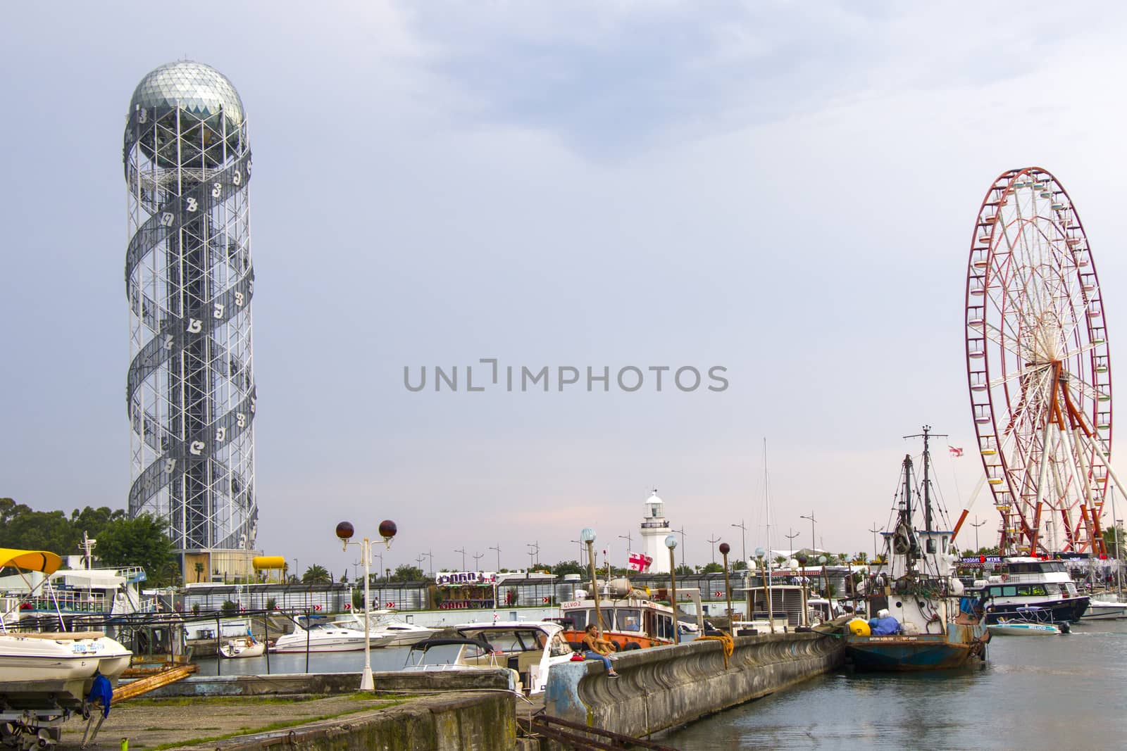 BATUMI, GEORGIA - JULY 08, 2020: Batumi harbor and port, Alphabet tower, boats and ships. City landscape of Batumi.
