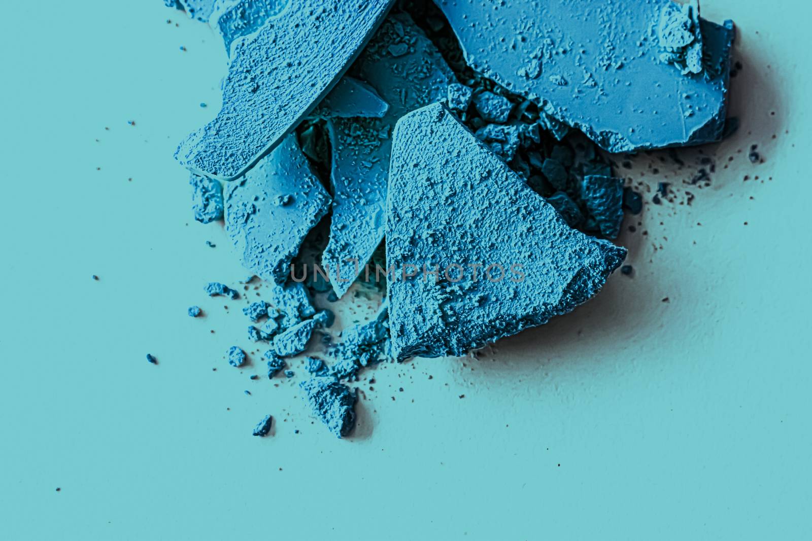 Blue eye shadow powder as makeup palette closeup, crushed cosmet by Anneleven